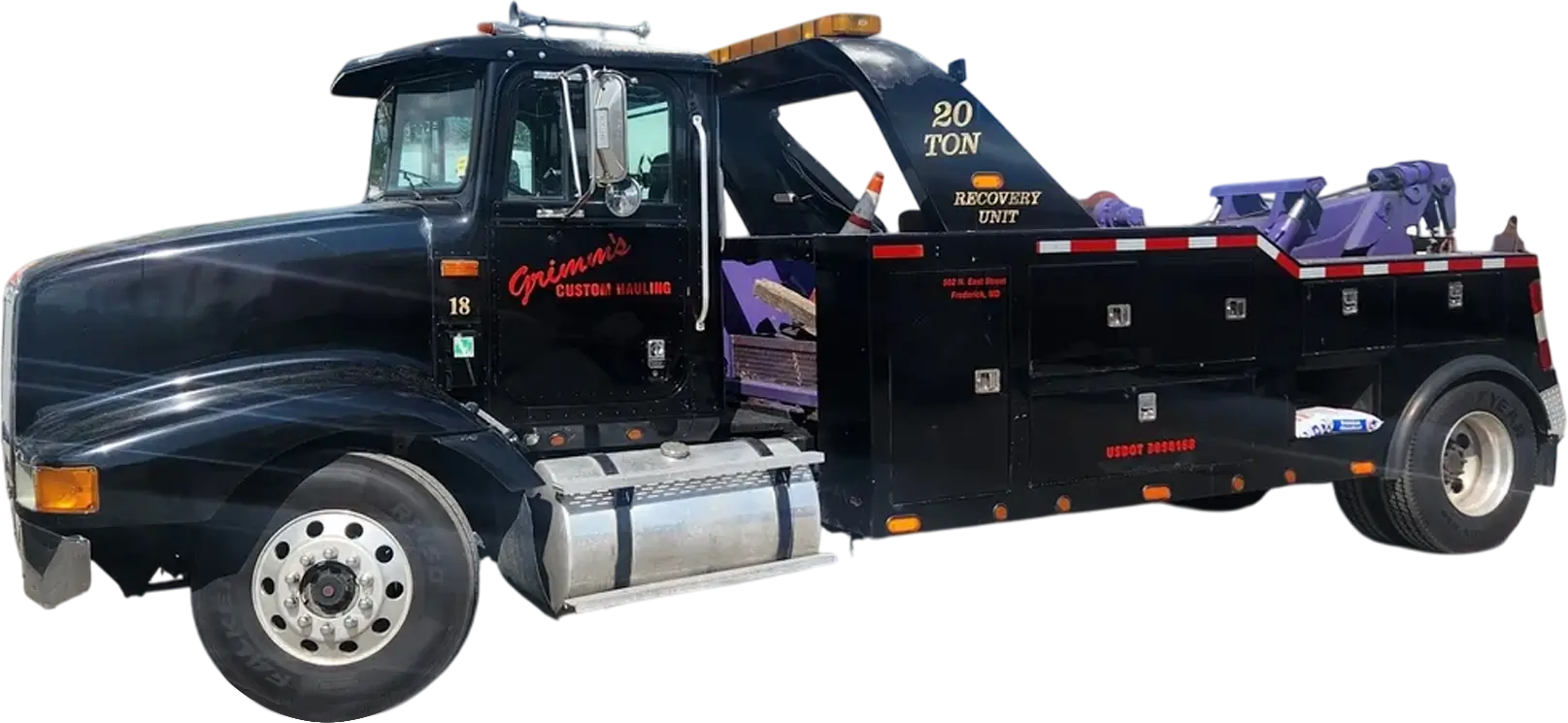 A black tow truck with the back open.